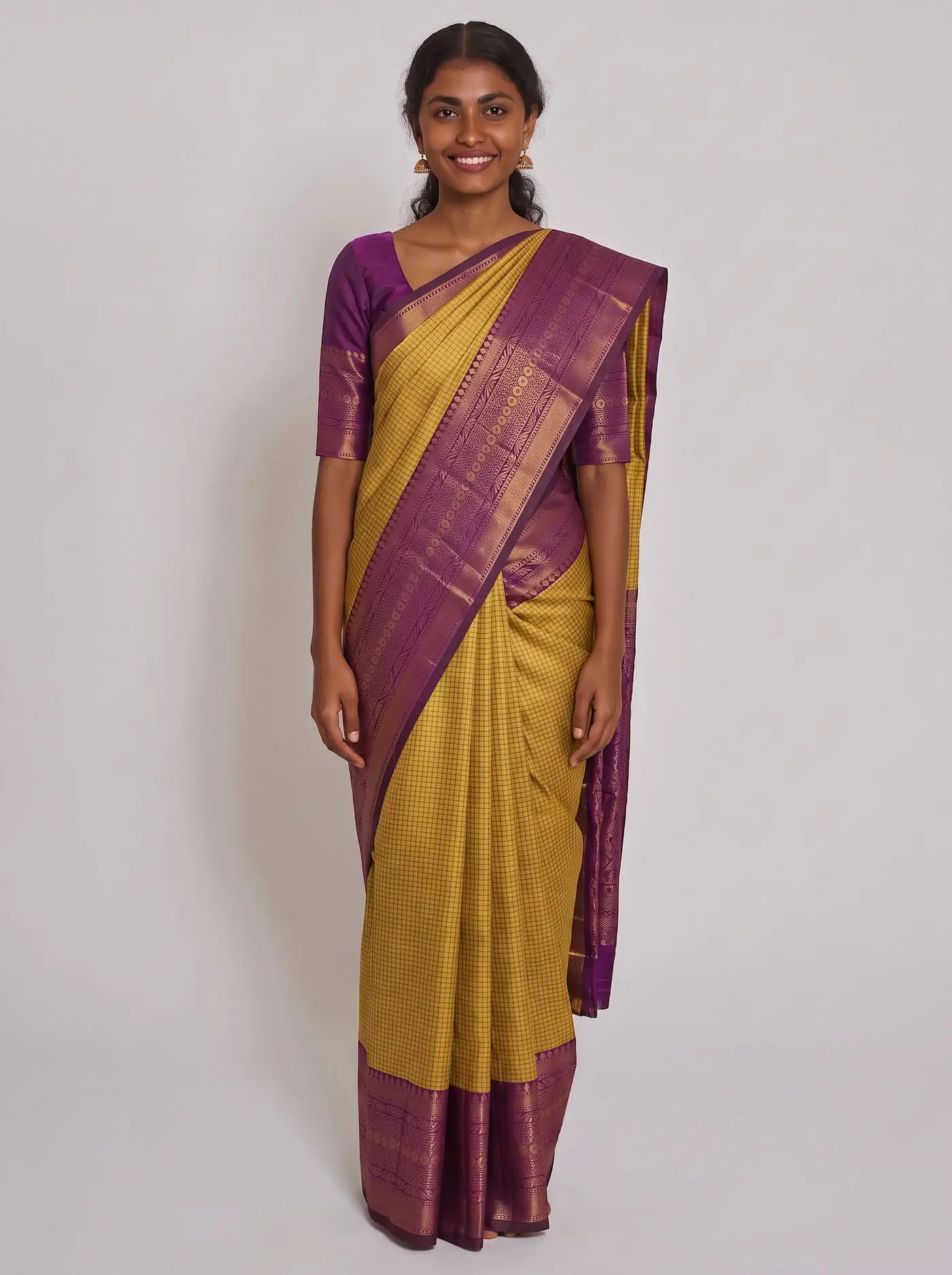 The same saree worn by a medium-skin house model on a light grey studio backdrop